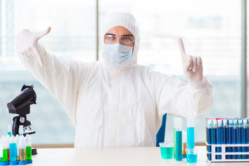 Young chemist pressing virtual buttons in lab