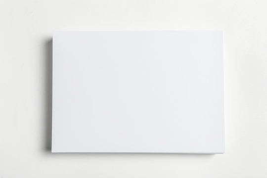 White business card on wooden table. Blank portrait A4.