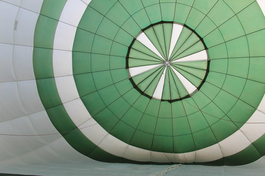 inside of a green and white hot air balloon as it inflates