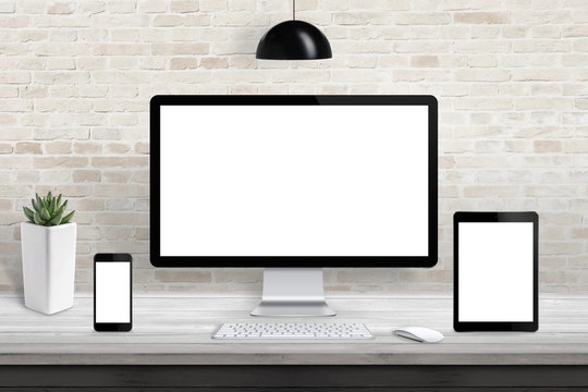 Responsive display devices for web site, design promotion. Isolated screen for mockup. Brick wall in background.