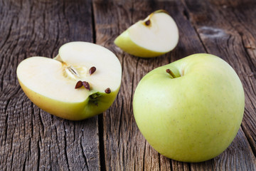 Sliced apple on rustic wooden table, close up view
