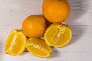 Fresh oranges on white wooden table