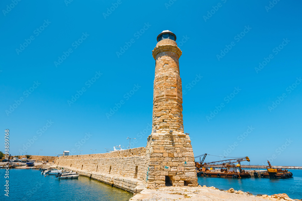 Wall mural lighthouse in old harbor in rethymno, crete, greece