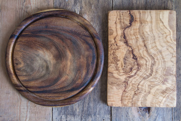 Chopping boards of different shapes on a wooden background. View from above.