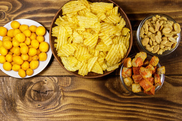 Mix of snacks for beer on wooden table