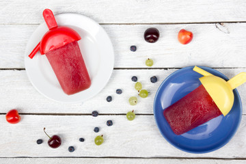 Ice cream. Berries. Homemade Cherry, currant, blueberries, gooseberries, raspberries, blackberries, strawberries, apricots, ice cream on rustic table, frozen fruit juice, vintage style, top view.
