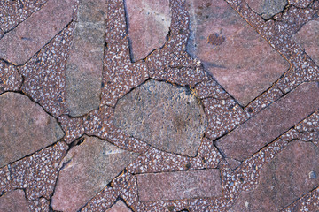 Red granite and stones with a marble pattern, texture, background. Close-up