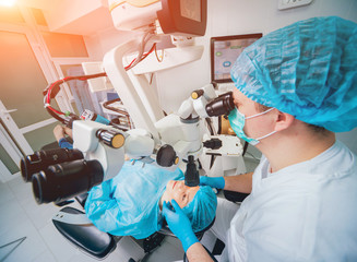 Eye surgery. A patient and surgeon in the operating room during ophthalmic surgery. Vision...