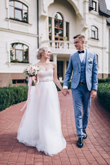 Fototapeta premium Walking newlyweds in nature.