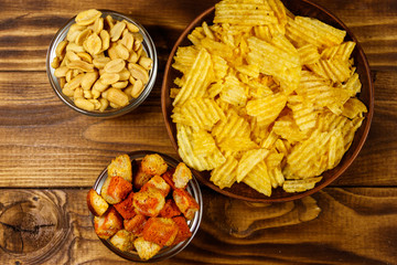 Mix of snacks for beer on wooden table