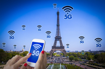 Digital composite of 5G with Paris night lights on the background.5G world summit event, High speed mobile web technology concept