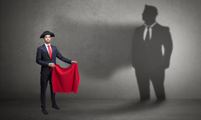 Obraz premium Businessman standing with red cloth on his hand and his shadow on the background 
