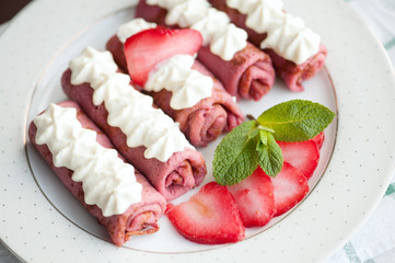 Pink pancakes with strawberries, five french style crepes