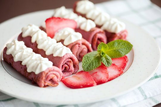 Pink pancakes with strawberries, five french style crepes