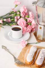 Traditional French eclairs with coffee. Good Breakfast. Closeup. On white background