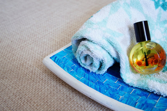 olled up towel, jar with aromatic liquid