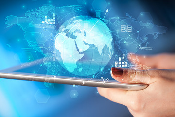 Hand using tablet with multinational worldwide estate report concept
