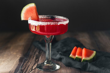 Red watermelon margarita cocktail on vintage dark background