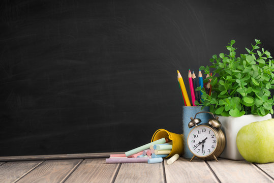 On the school board, school supplies. With an empty place for inscription or advertising.