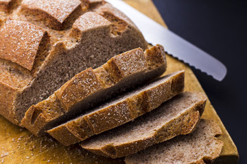 Sliced rye bread on cutting board closeup