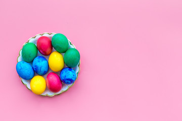 Fototapeta na wymiar Colorful easter eggs in plate on plate background top view mockup