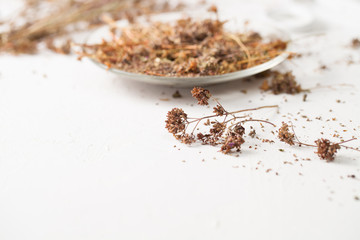 The dried herb oregano on a white table
