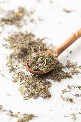 Fototapeta premium The dried herb thyme on a white table