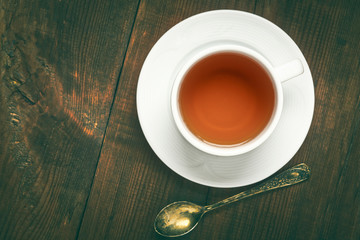 Closeup of cup of tea on vintage wooden background