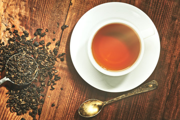 Closeup of cup of tea on vintage wooden background