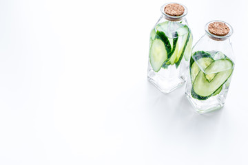 Drink for weight loss. Water with cucumber on white background top view copy space