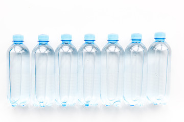 Drinking water in bottles on white background top view