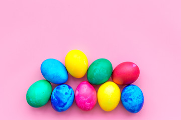 Easter celebration with colorful eggs. Pink background top view mock up