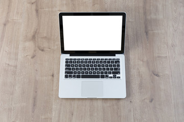Laptop on wood table. Top view
