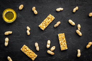 Energy protein snacks with peanuts on black background top view