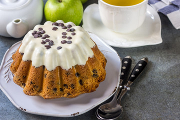 Glazed fresh cake on a round wooden stand
