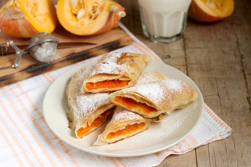 Traditional Romanian or Moldovan pumpkin strudel vertuta served with milk. Rustic style.