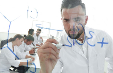 close up of a Man scientist working with formulas