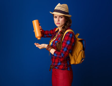 woman hiker against blue background experiencing lack of water
