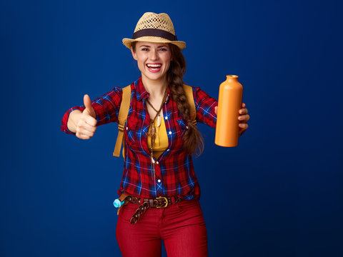 happy woman hiker with bottle of water showing thumbs up