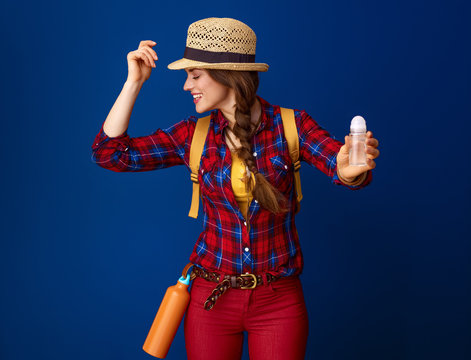 traveller woman against blue background showing antiperspirant