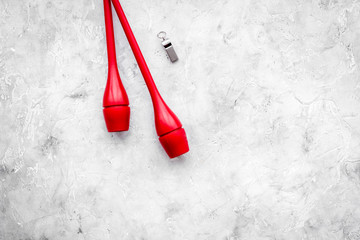 Maces for rhythmic gymnastics on grey background top view copy space