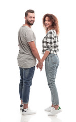 Rear view of happy couple holding hands and looking at camera