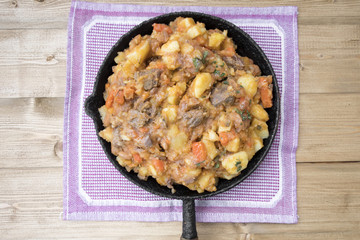 stewed vegetables with beans and meat in a frying pan