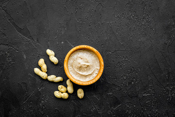 organic scrub with peanut for homemade spa on black background top view mockup