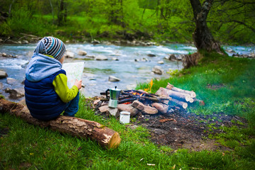 The boy near the fire.