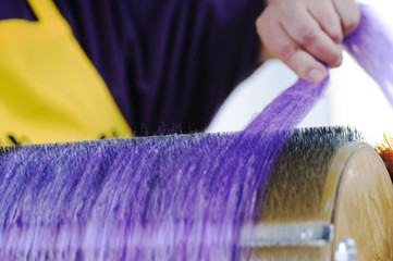 Felting wool. The step of combing the material in a special carding machine.