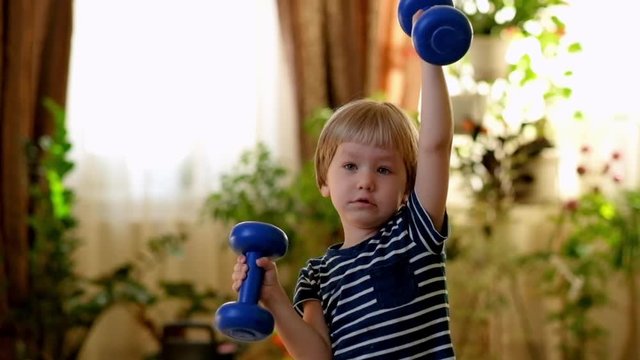 Little Boy Doing Exercises with Dumbbells