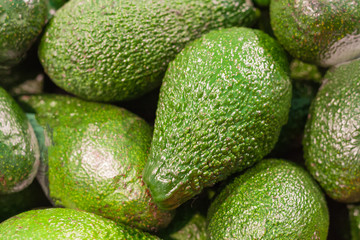 A pile of avocados in the market (background, texture)