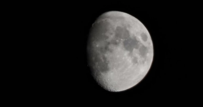 Natural night background with dark sky and half Moon, Earth satellite. Waxing gibbous phase.