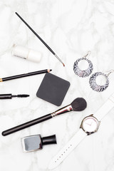Cosmetics and accessories black and white on a marble background. Vertical